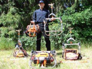 Bryan Coffey holding a Water Winger rooftop wildfire sprinkler with additional kits